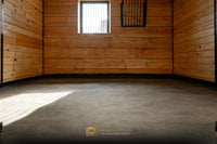 Full-privacy horse stall featuring a StableComfort mattress on the flooring and a barn window for added ventilation.