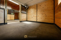 Horse Stall flooring features a stable comfort mattress — a wall-to-wall waterproof stall mat system. A Full privacy wood partition, and added stall fan.