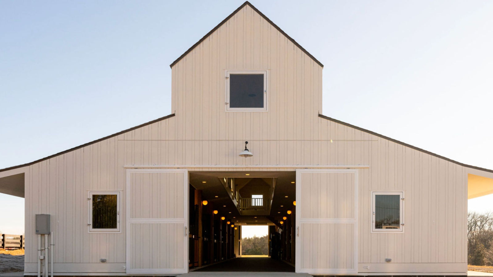 Large white barn with Sliding Barn Entry Doors and Barn Windows