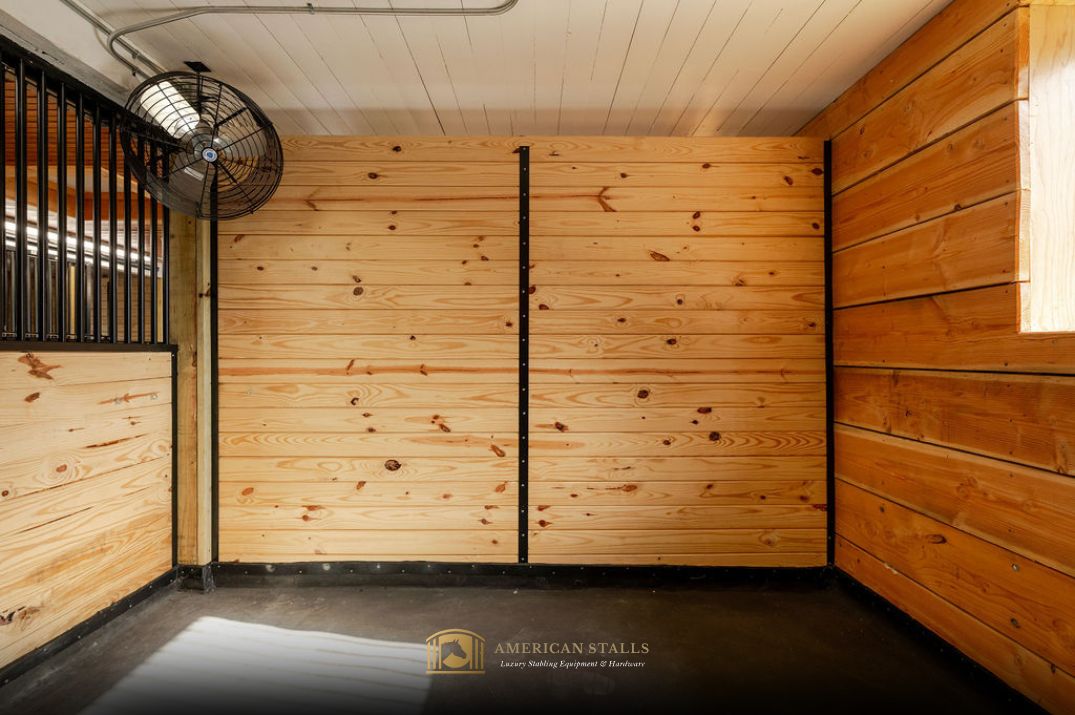 Grilled Stall Front with lumber fill. A full privacy wood partition and stall fan. Stall flooring features a stable comfort mattress — a wall-to-wall waterproof stall mat system. 